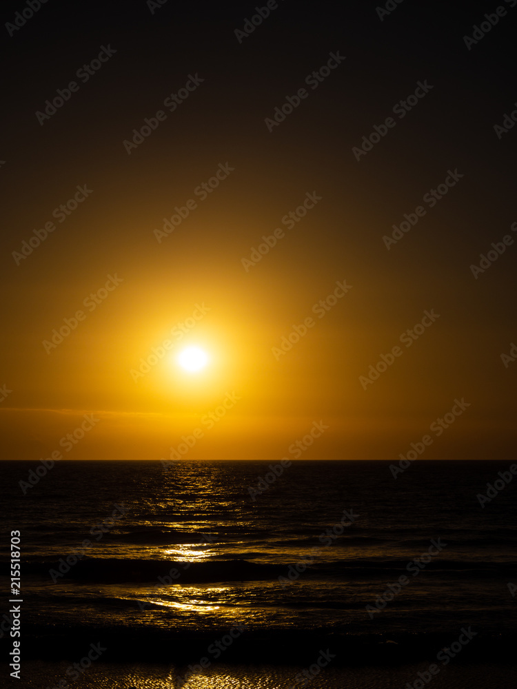 A simple and basic sunset over the sea and waves