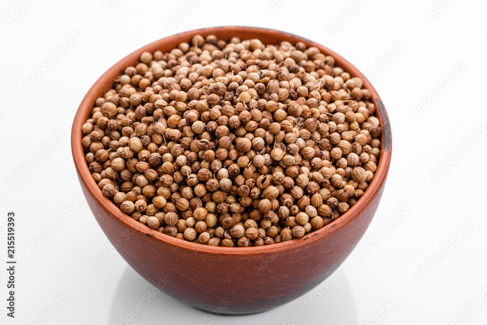 fragrant coriander seeds on a white background fragrant coriander seeds on a white background