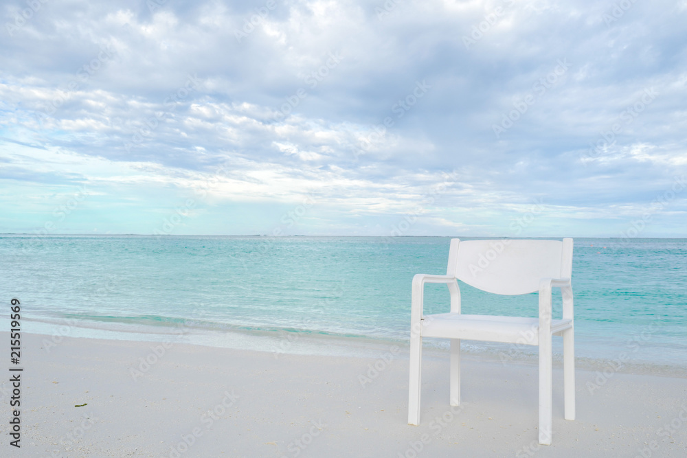 Summer concept , White chair on the beach white sand and turquoise sea color at maldives on the weekend holidays