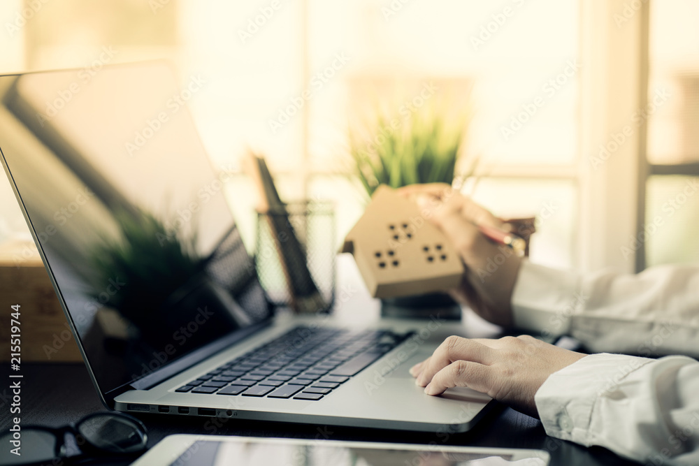 Hand of Business people calculating interest, taxes and profits to invest in real estate and home buying