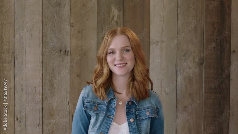 young stylish red head woman portrait of beautiful girl smiling happy at camera wearing denim jacket wooden background young stylish red head woman portrait of beautiful girl smiling happy at camera wearing denim jacket wooden background