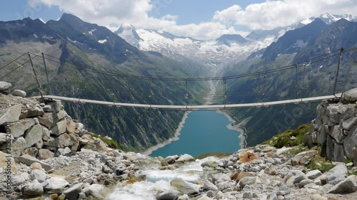 Rope Bridge near Olpererhütte with Schlegeisspeicher Water Reservoir and Power Station at Zillertal Tirol Austria 4K photo