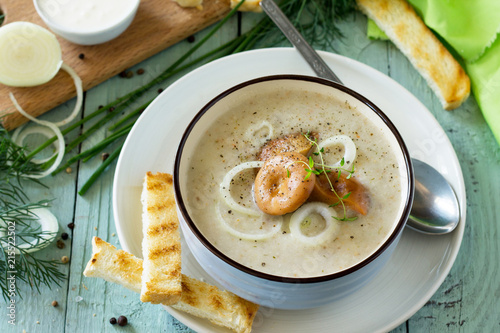 Diet menu. Puree soup mushrooms with croutons in a bowl on a kitchen wooden table. The concept of healthy eating.