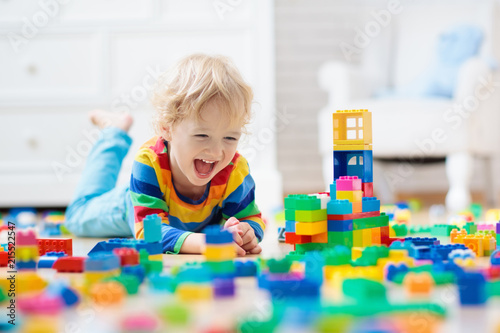 Vászonkép Child playing with toy blocks. Toys for kids.