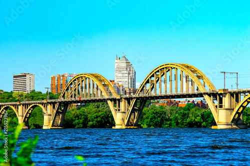 Summer Landscape of the Dnepr city with a railway bridge across the Dnieper river and a view of the skyscrapers and towers   of Dnepropetrovsk  (Dnipropetrovsk, Dnepr), Ukraine