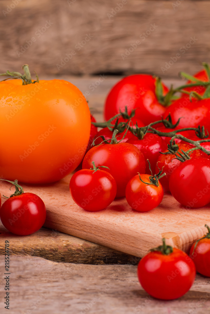 Pile of washed tomatoes on the table. Close up. Clean red and yellow tomatoes. Pile of washed tomatoes on the table. Close up. Clean red and yellow tomatoes.