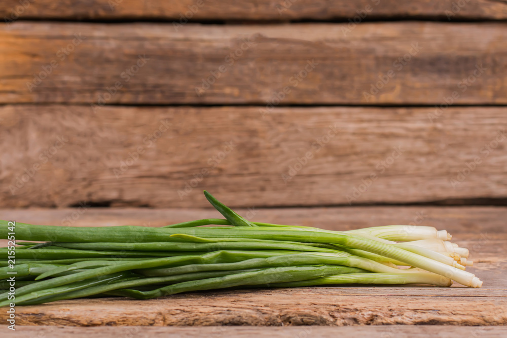 Fresh green onion in a bunch. Old rustic wooden table background. Fresh green onion in a bunch. Old rustic wooden table background.