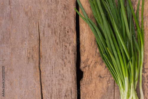 Fresh spring onion on wood. Close up. Top view  copyspace.