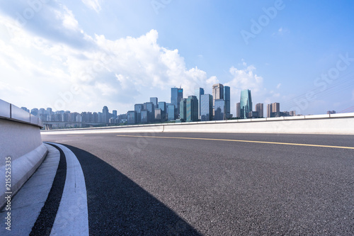 asphalt road with city skyline © THINK b