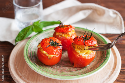 Baked tomatoes stuffed with scrambled eggs photo
