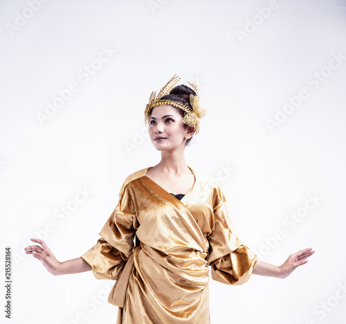 The beauty lady is wearing glod dress ,put butterfly crown on head, posing on white background,The fairy ballet pattern