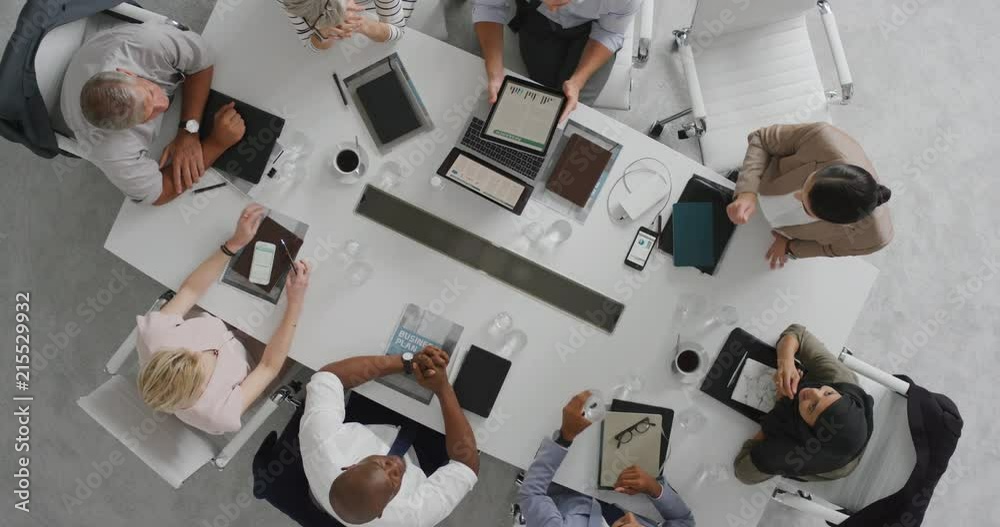 creative business professionals meeting in boardroom multi ethnic corporate leaders collaborating sharing ideas planning strategy using tablet pc overhead