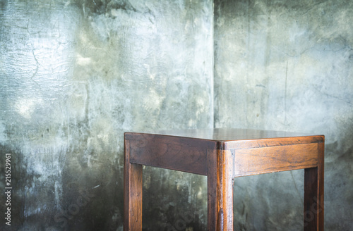 Old wood chair in the corner of cement wall room