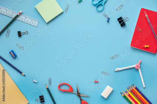 Creative, fashionable, minimalistic, Back to school education concept, school supplies stationery equipment on blue backboard Flat lay with copy space.