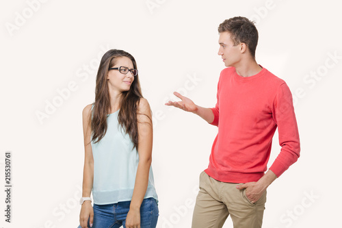 Studio shot of disgruntled couple wearing casual clothes standing back to back frowning their faces. Discord in the relationship. Divergence of points of view