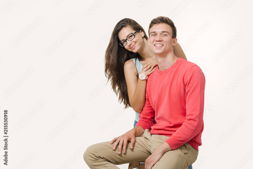 Happy lovely couple hugging and smiling looking at camera on white background Happy lovely couple hugging and smiling looking at camera on white background