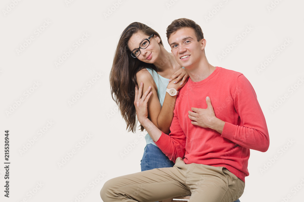 Happy lovely couple hugging and smiling looking at camera on white background Happy lovely couple hugging and smiling looking at camera on white background