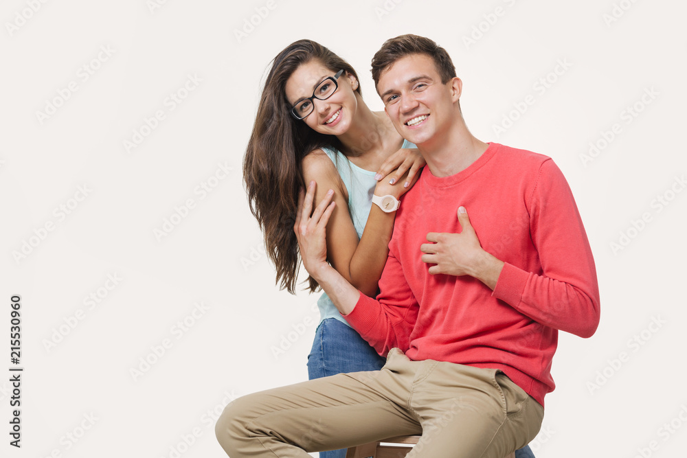 Happy lovely couple hugging and smiling looking at camera on white background Happy lovely couple hugging and smiling looking at camera on white background