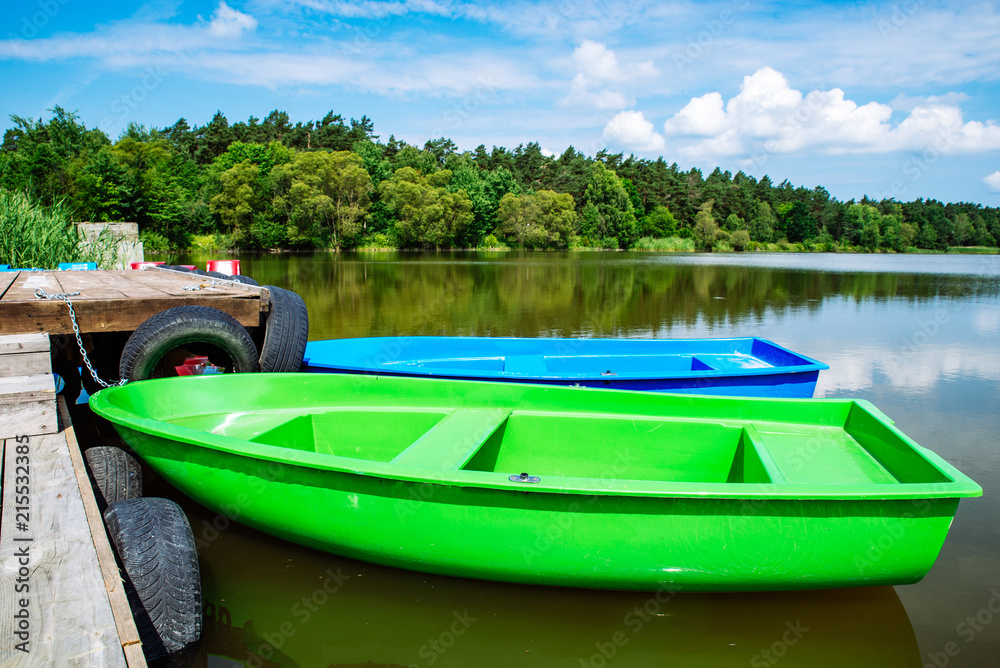 boats near wooden dock. peaceful landscape. nobody boats near wooden dock. peaceful landscape. nobody