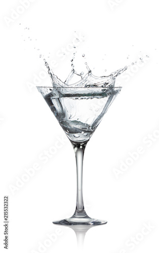 glass with splash of transparent alcohol drink