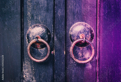 Fotografie Old wooden door with iron ring handles.