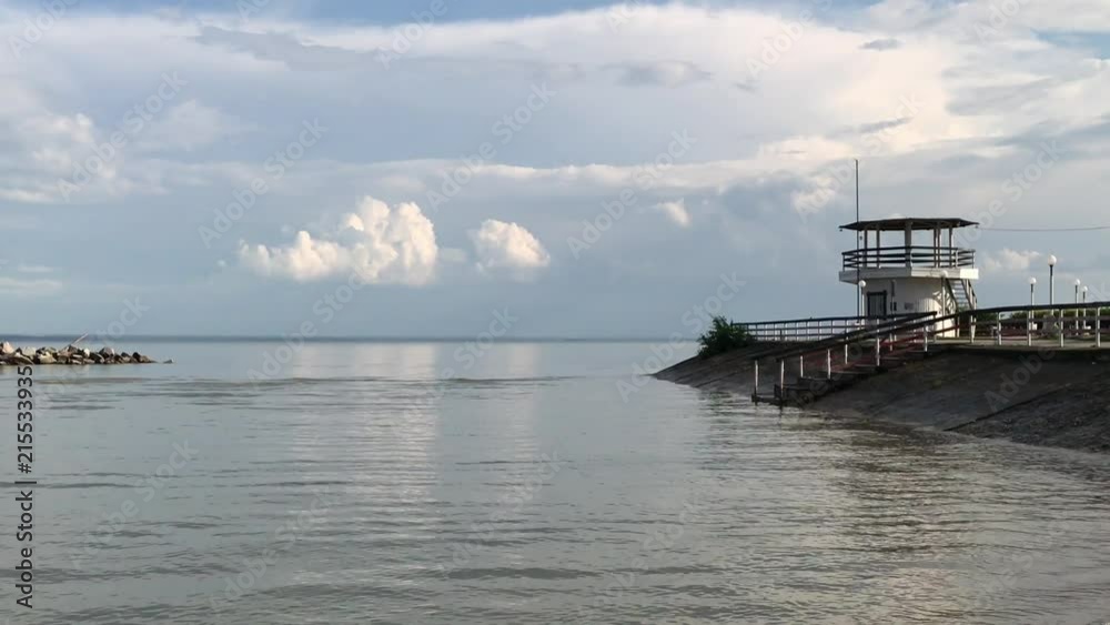 Russia, Novosibirsk - July 27, 2017: Novosibirsk reservoir is an artificial reservoir on the Ob river. Beach Boomerang. Views on water and sky, summer cloudy day, natural weather phenomena Russia, Novosibirsk - July 27, 2017: Novosibirsk reservoir is an artificial reservoir on the Ob river. Beach Boomerang. Views on water and sky, summer cloudy day, natural weather phenomena