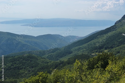 Panoramic view of the adriatic sea and mountains in Croatia, Dalmatia. In the valley lies the town Senj. South Europe. Aerial view down from Velebit national park.