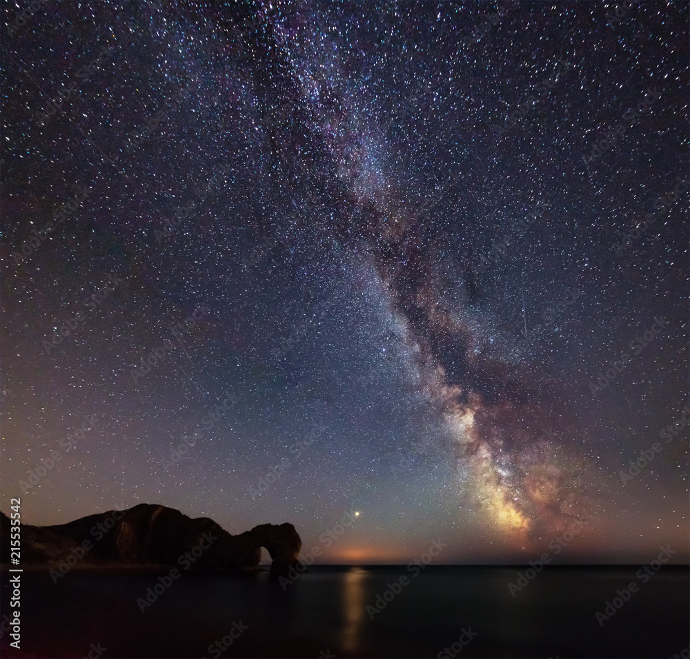 Beautiful vibrant image of Milky Way galaxy over sea landscape in Dorset England