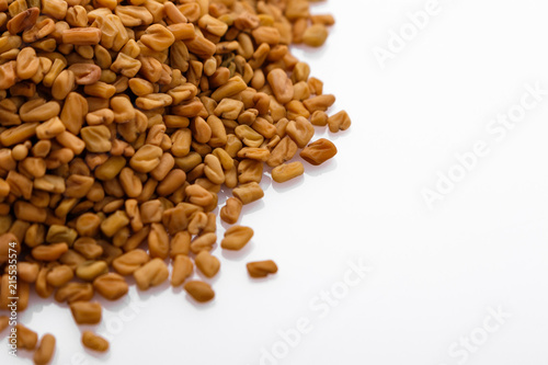 fragrant grains of fenugreek on a white background