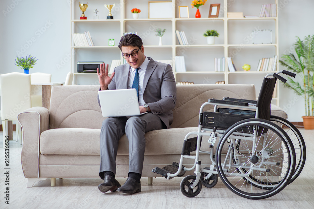 Dsabled businessman on wheelchair working home Dsabled businessman on wheelchair working home