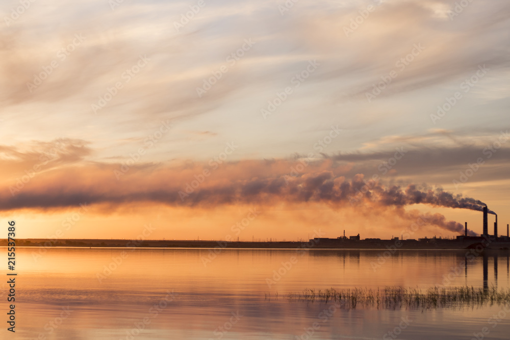 the sunset on the lake in the background of the factory the sunset on the lake in the background of the factory