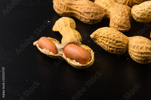 Peanuts in shell on dark background, close up
