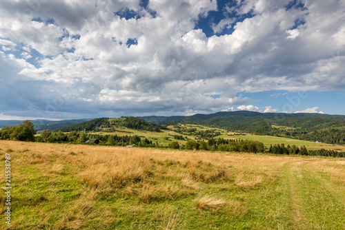 Picturesque rural landscape in summer day with amazing clouds on the sky. Pieniny mountains  Poland.