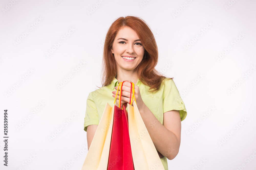 Young redhead girl holding a lot of shopping bags Young redhead girl holding a lot of shopping bags