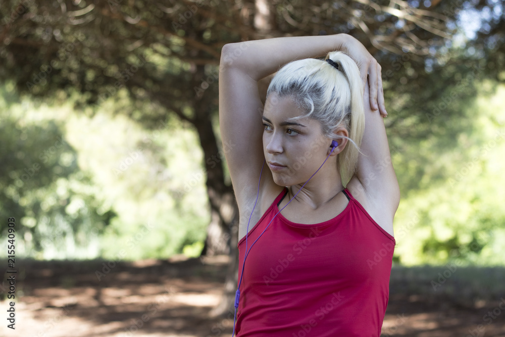 Pretty young girl exercising in the forest Pretty young girl exercising in the forest
