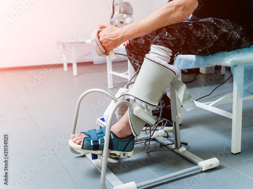 Patient on CPM (continuous passive range of motion) machines. Device to provide anatomically correct motion to both the ankle and subtalar joints. photo