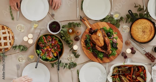 top view of young multi ethnic friends preparing table enjoying thanksgiving lunch together talking bonding over healthy meal time lapse tracking