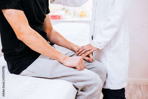 Physician doctor comforting a male patient in hospital room