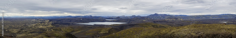 Colorful wide panorama, panoramic view on Volcanic landscape in Lakagigar, Laki Volcano crater chain with green lichens, moss and lakes Kambavatn and Lambavatn, Iceland, moody sky background
