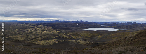Colorful wide panorama, panoramic view on Volcanic landscape in Lakagigar, Laki Volcano crater chain with green lichens, moss and lakes Kambavatn and Lambavatn, Iceland, moody sky background