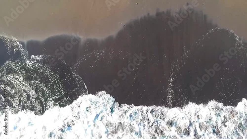 Aerial bird eye rocket view of dark ocean beach surf in Japan. photo