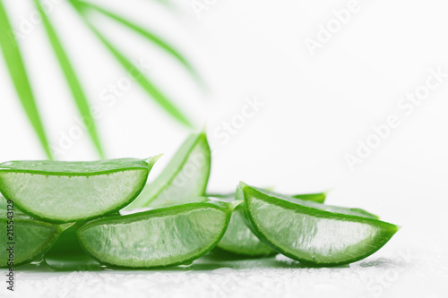 Aloe vera leaf slices with gel on white background.