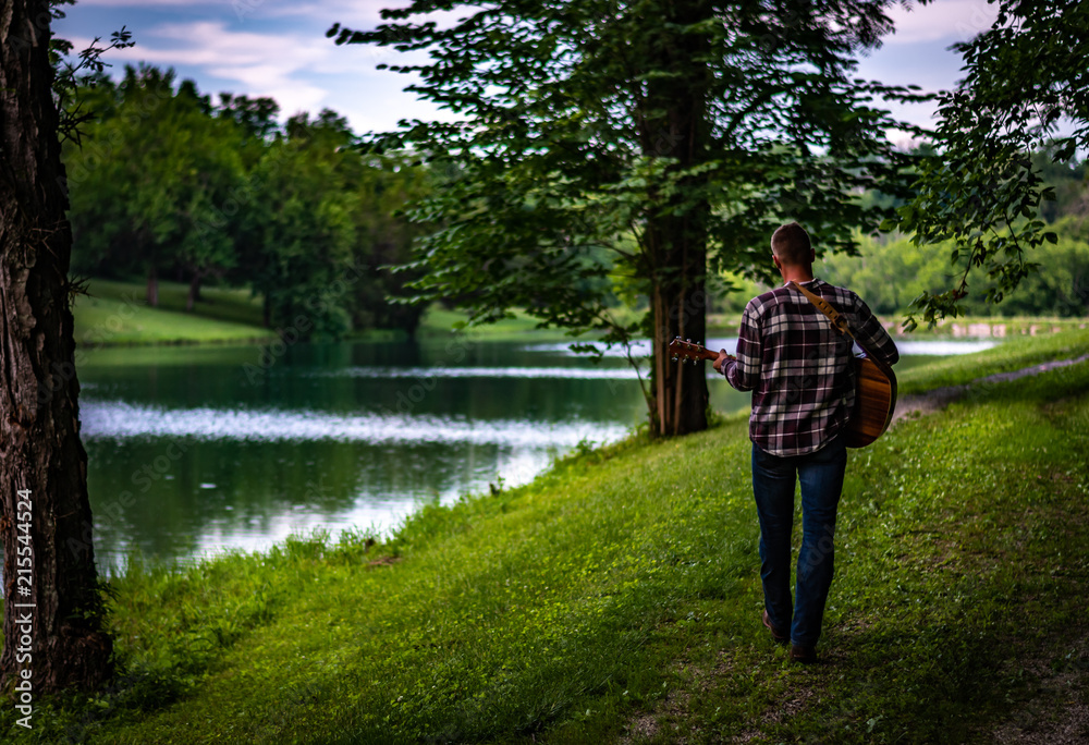 man playing acoustic guitar