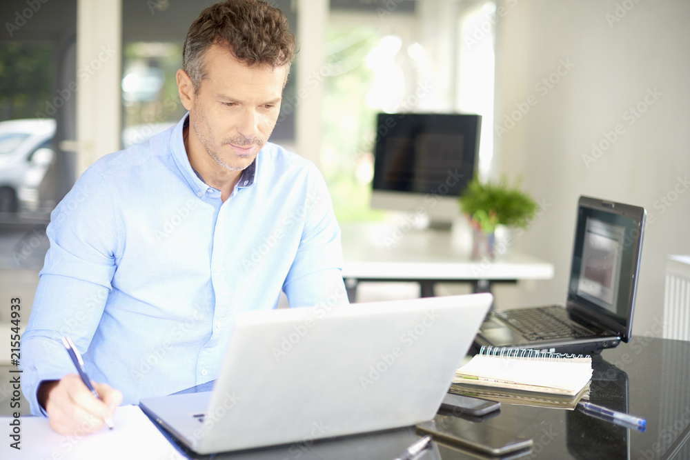 Businessman working on laptop and doing some paperwork Businessman working on laptop and doing some paperwork