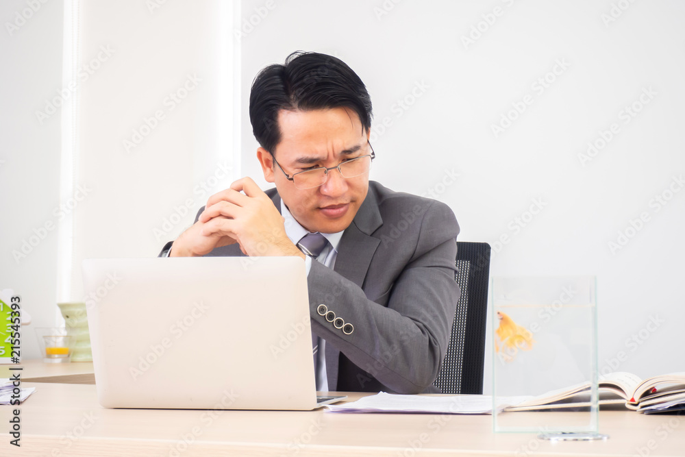 Asian business man in working room. Serious and thinking action.