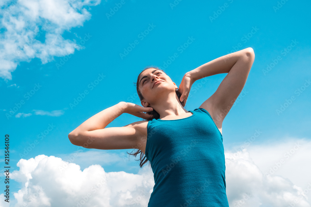 beautiful sports girl on a blue sky background after a workout beautiful sports girl on a blue sky background after a workout