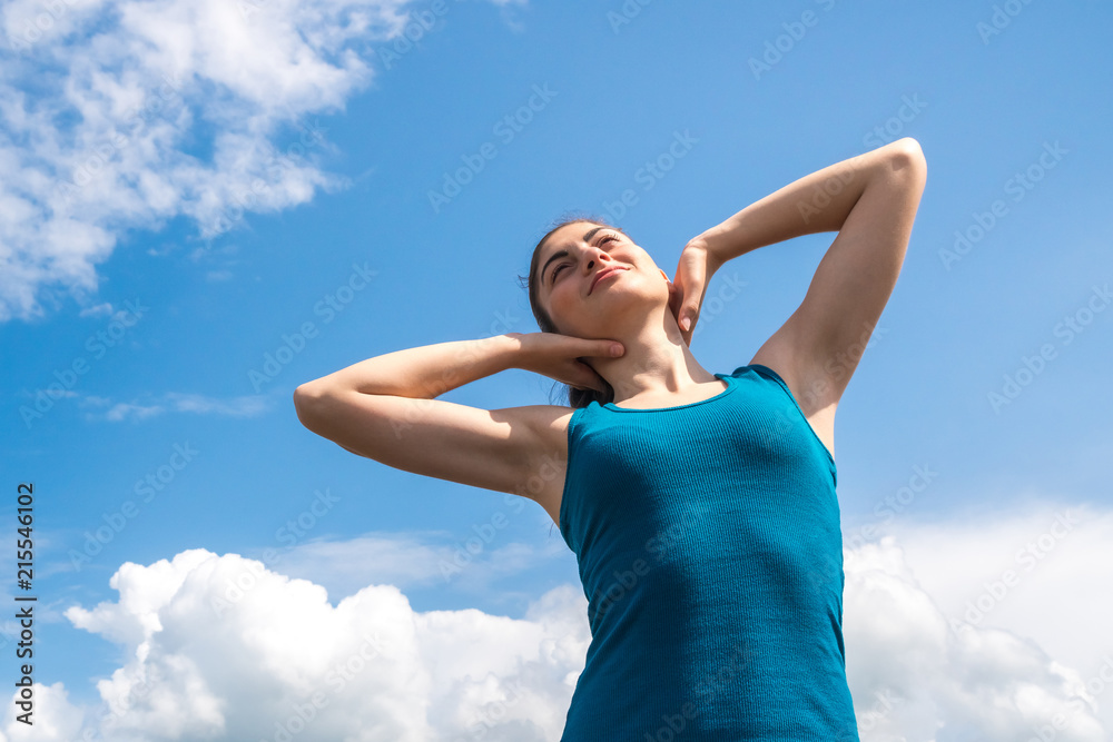 beautiful sports girl on a blue sky background after a workout beautiful sports girl on a blue sky background after a workout
