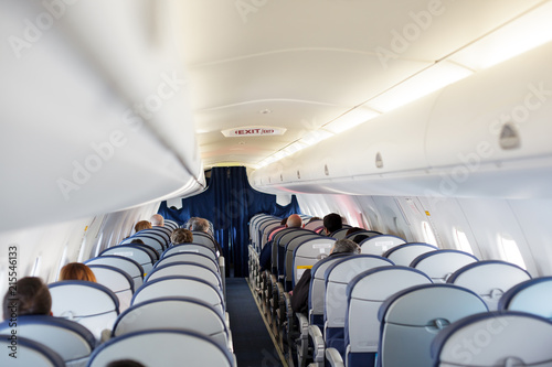 Passenger inside cabin flight gray interior half empty salon problem porthole window photo