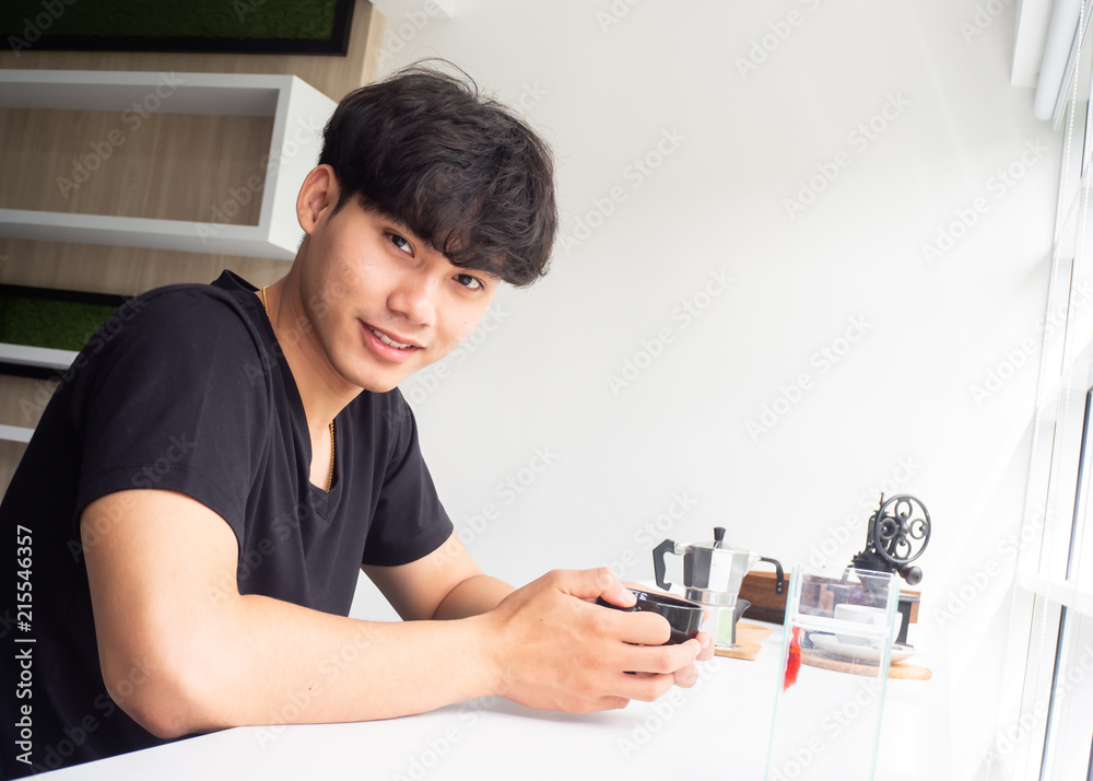 Handsome man holding cup of coffee in cafe. Handsome man holding cup of coffee in cafe.