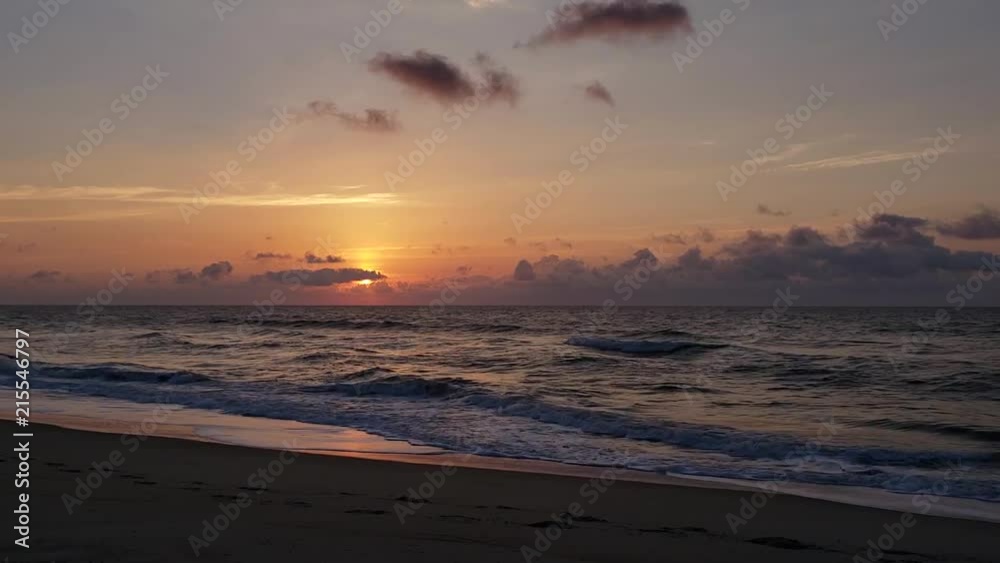 An early morning sunrise on Kure Beach North Carolina with waves crashing